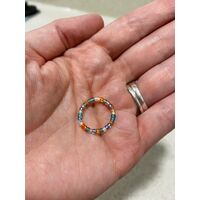 Hand holding a bead ring hand wea