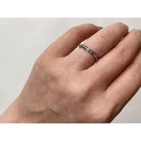 Hand wearing a bead ring