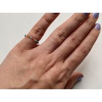 Hand wearing a bead ring