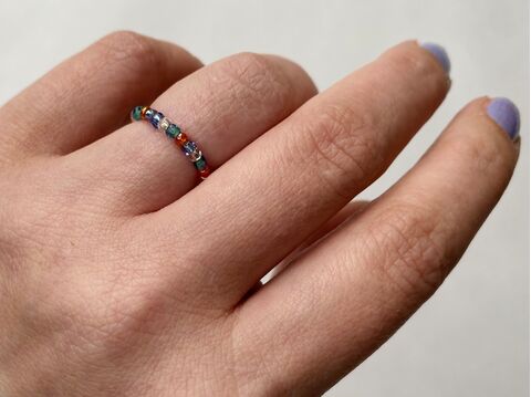 Hand wearing a bead ring