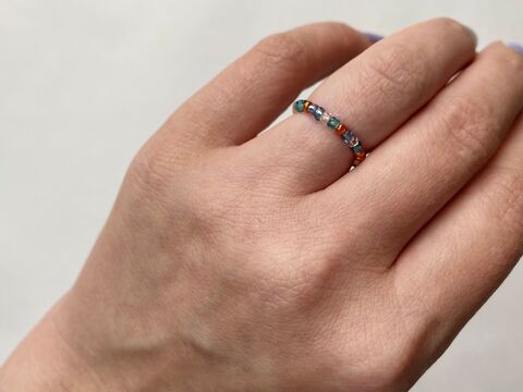Hand wearing a bead ring